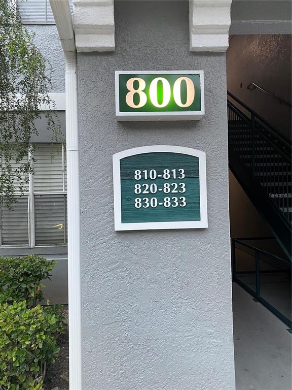 A building exterior wall displays a large number 800 and a sign listing unit ranges — 18001 RICHMOND PLACE DRIVE UNIT 830, TAMPA, FL