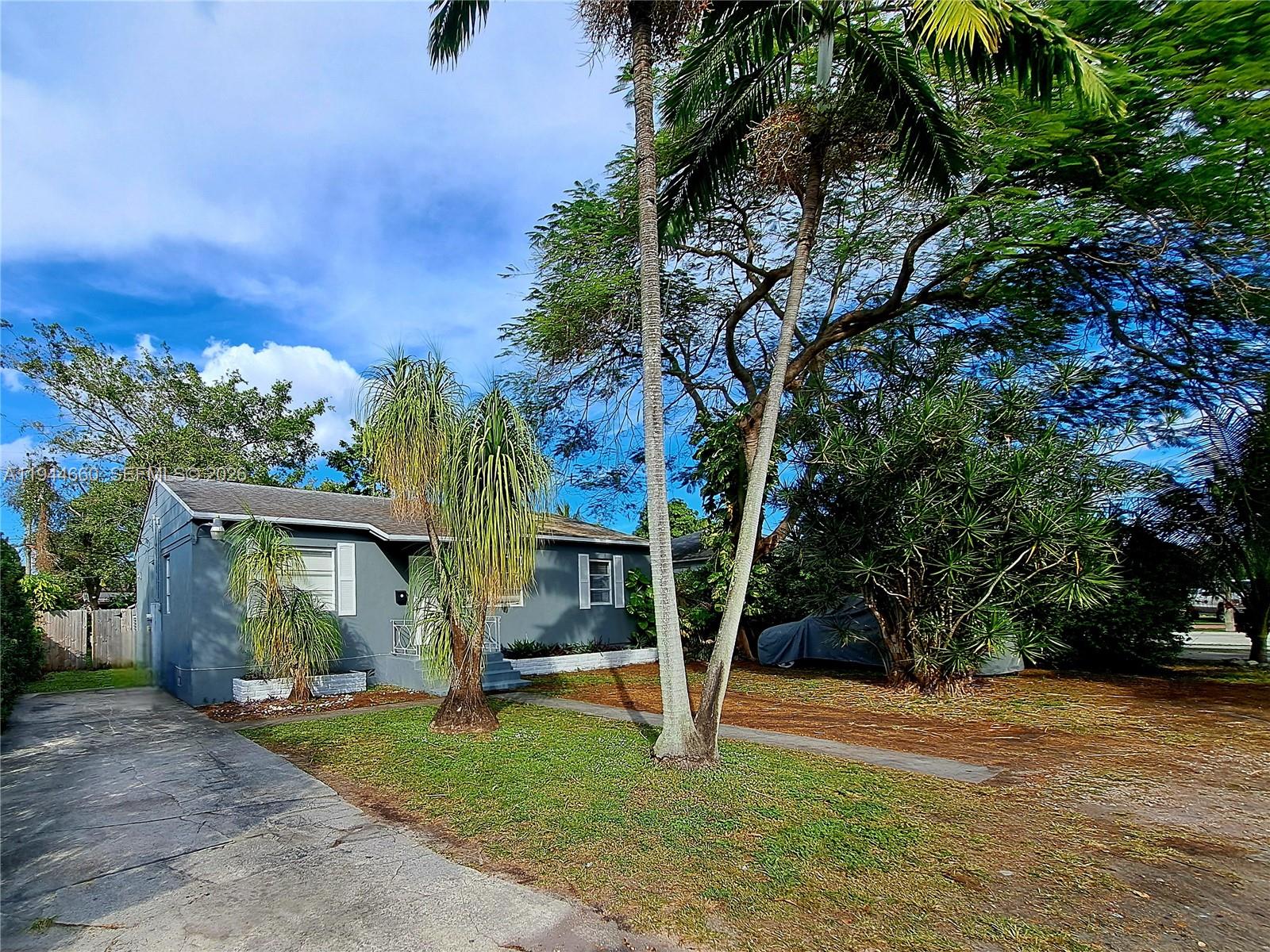 A gray single-story house with a palm tree in the front yard — 335 NW 102nd St, Miami FL 33150, MIAMI, FL