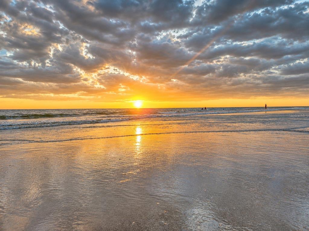 A sunset view over the ocean with waves washing onto a sandy beach — 17400 GULF BOULEVARD N UNIT B-5, REDINGTON SHORES, FL