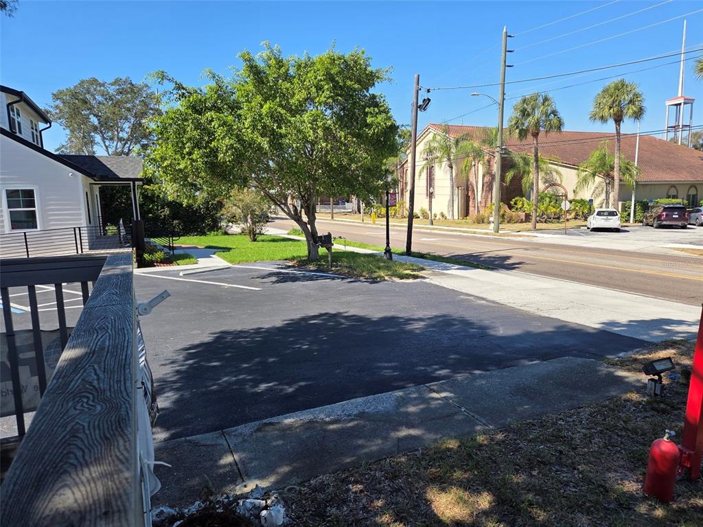 A paved parking area sits next to a building, a tree, and a street — 528 E TARPON AVENUE, TARPON SPRINGS, FL