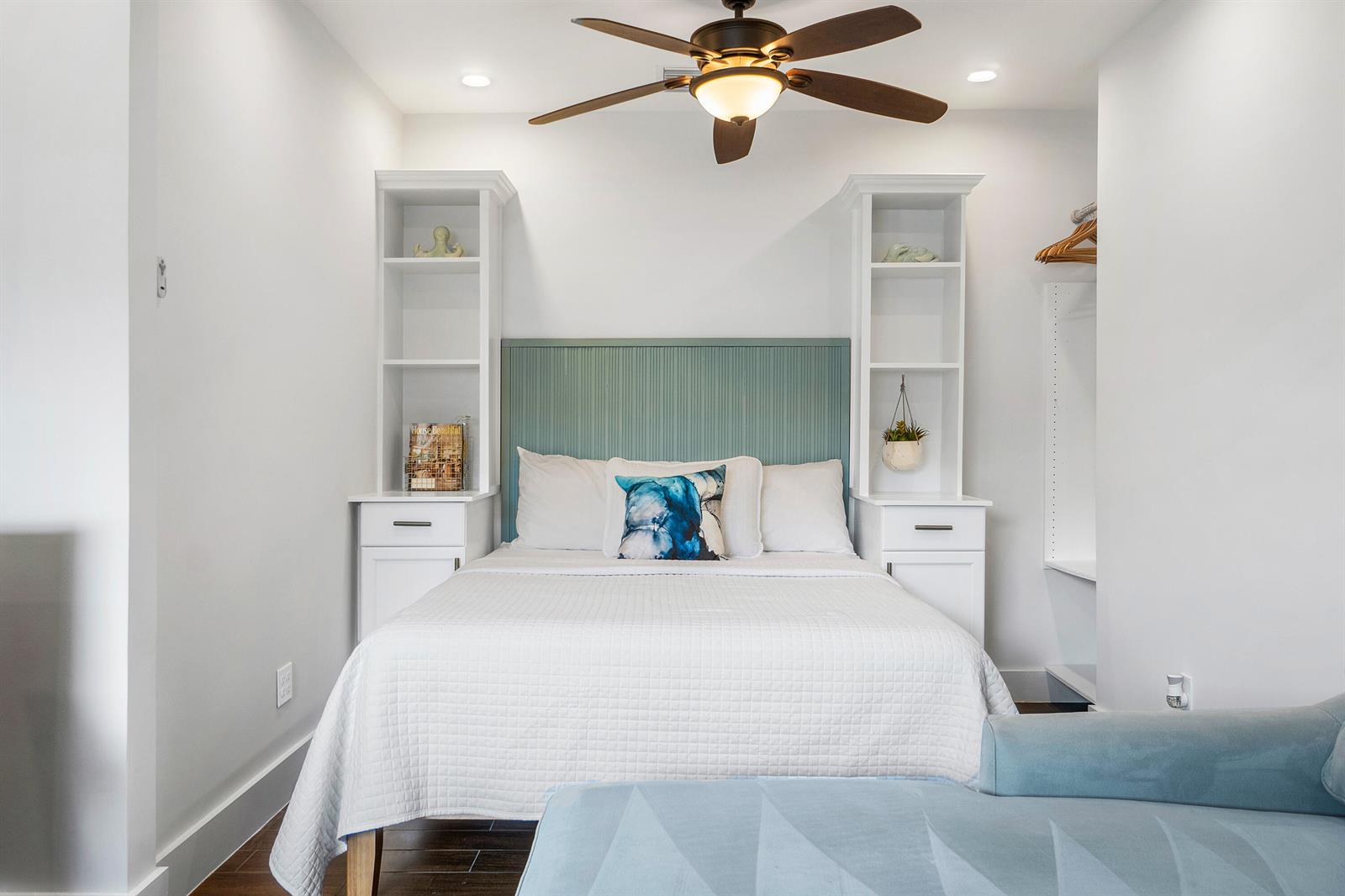 A bedroom features a bed with a teal headboard between two white built-in shelving units — 43 W Plumosa Lane, FL 33467, FL