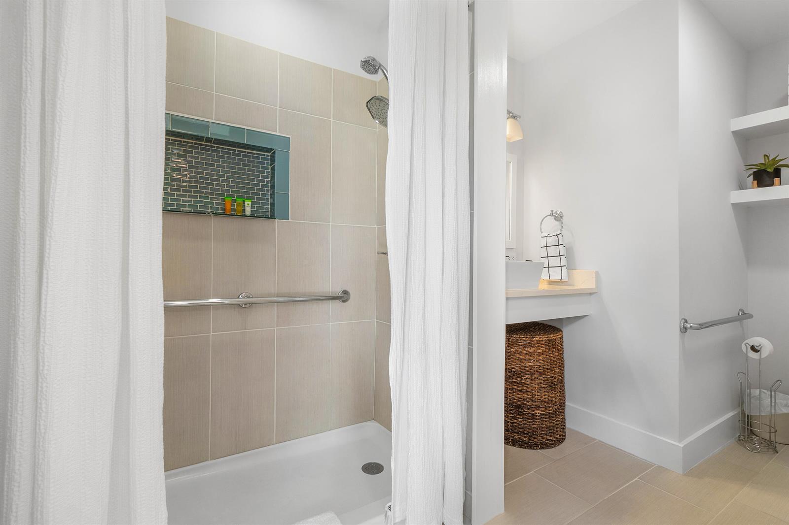 A bathroom features a tiled walk-in shower with a grab bar and a vanity area — 43 W Plumosa Lane, FL 33467, FL