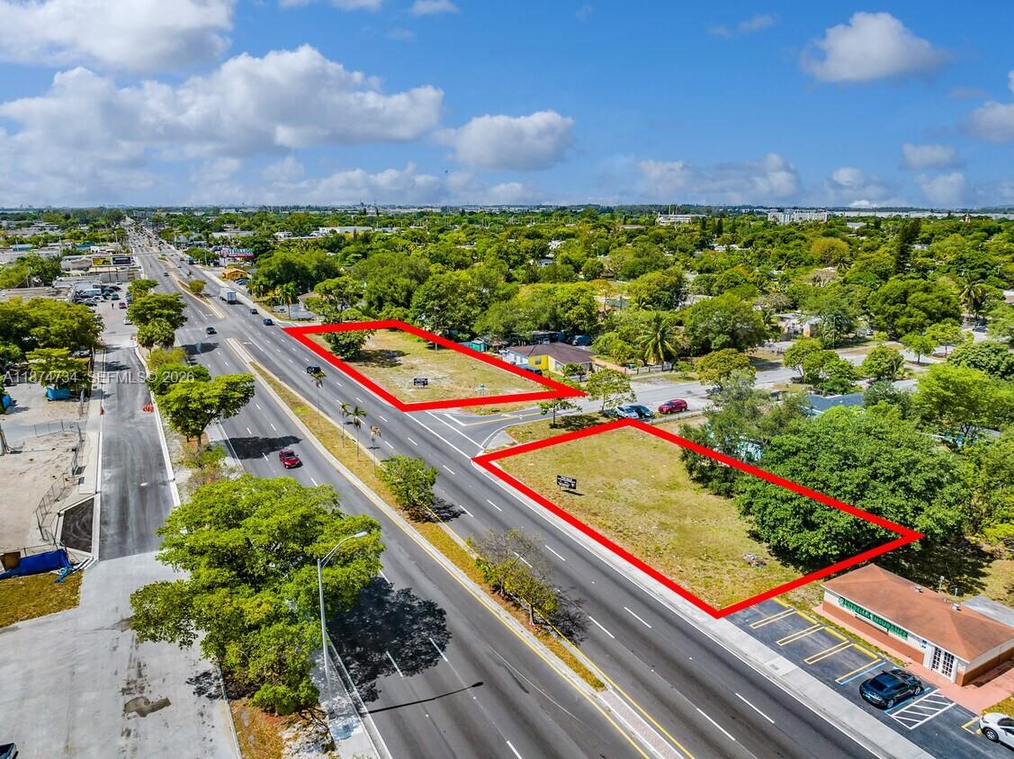 An aerial view shows two vacant, rectangular lots outlined in red along a multi-lane road — NW 27th, Opa-Locka FL 33054, OPA-LOCKA, FL