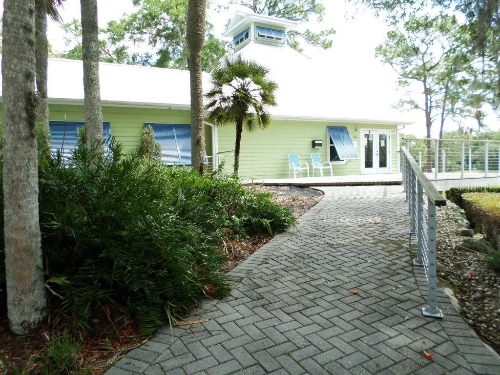 A light green house with a white roof and a brick walkway leading to it — 8621 SW 200TH CIR, DUNNELLON, FL