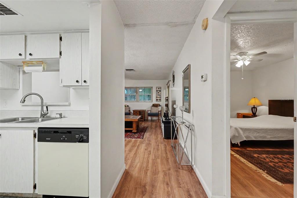 A view from a kitchen looking into a living area and an adjacent bedroom — 601 N HERCULES AVENUE UNIT 1004, CLEARWATER, FL