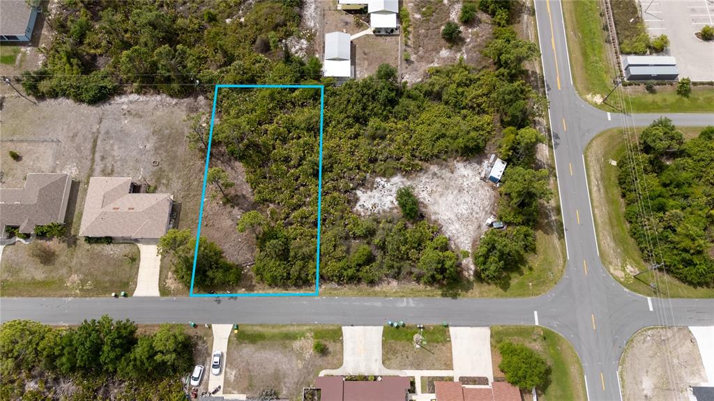 An aerial view shows a rectangular, wooded vacant lot outlined in blue along a road — 11299 KIMBERLY AVENUE, ENGLEWOOD, FL