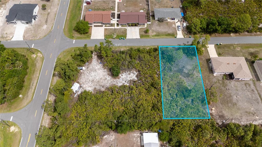 An aerial view shows a rectangular vacant lot highlighted in blue next to a house — 11299 KIMBERLY AVENUE, ENGLEWOOD, FL