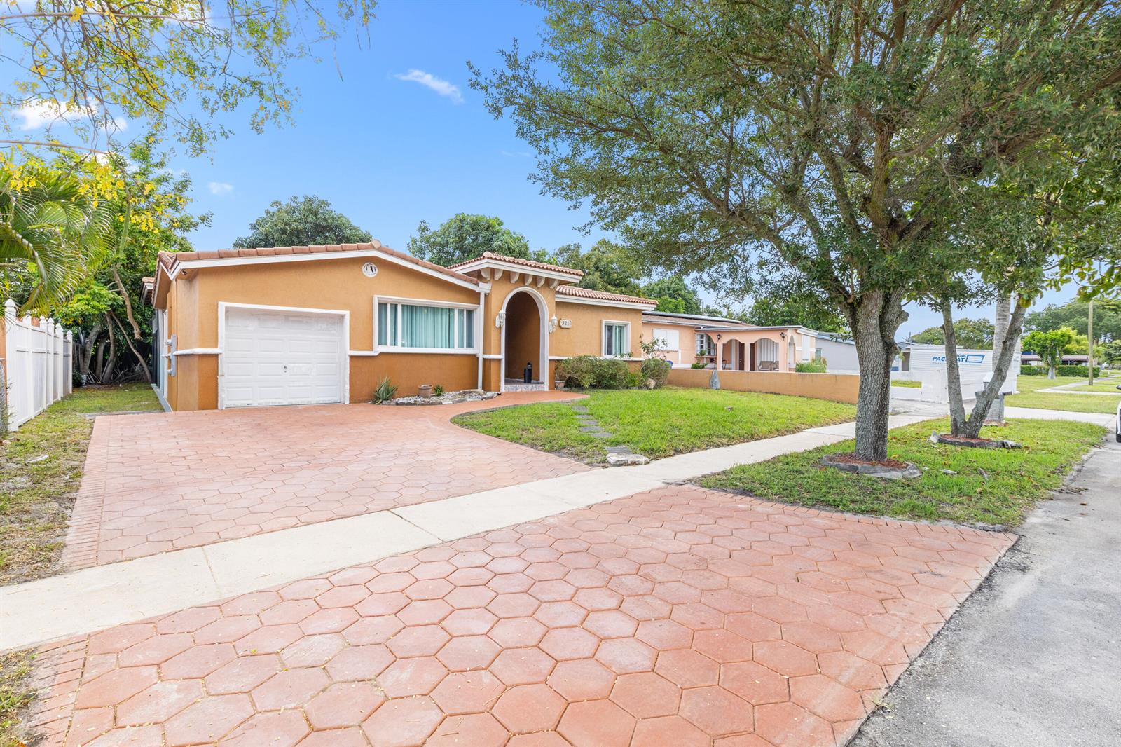A single-story orange house with a tiled roof, garage, and a hexagonal paver driveway — 321 N 72nd Terrace, Hollywood FL 33024, HOLLYWOOD, FL
