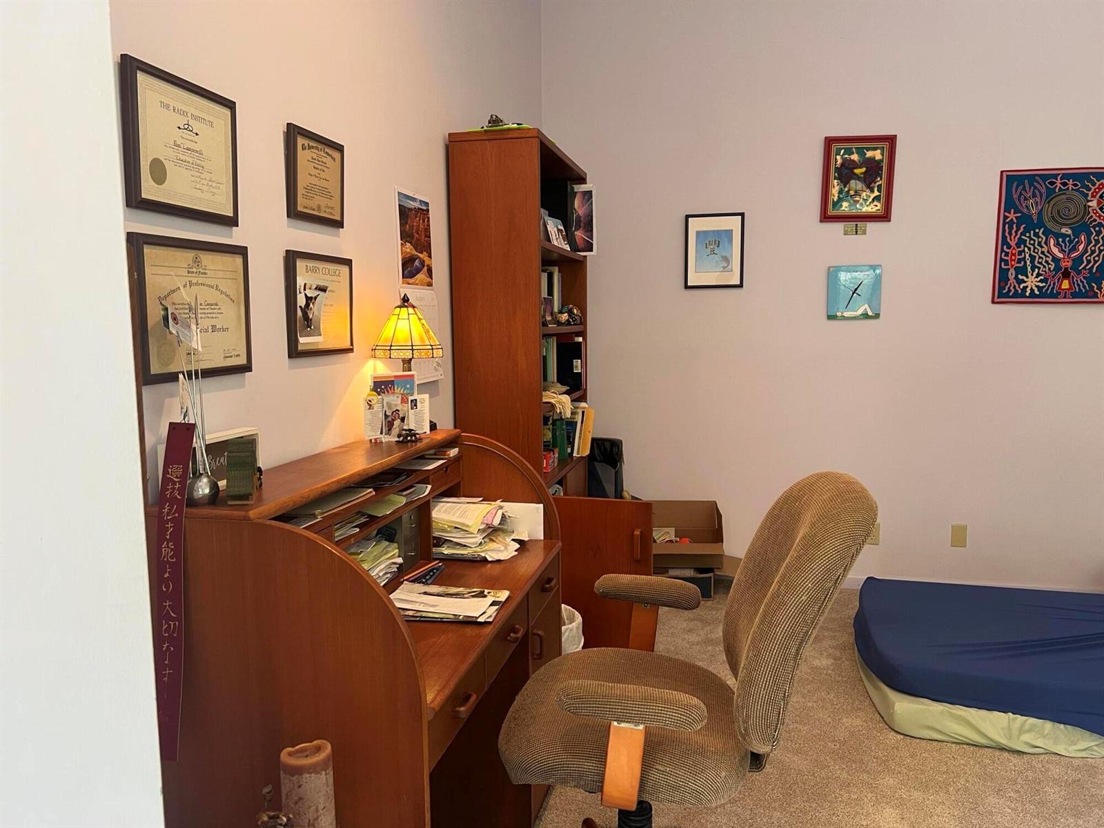 A home office features a wooden roll-top desk, a rolling chair, and wall-mounted artwork — 720 NE 3rd, Fort Lauderdale FL 33304, FORT LAUDERDALE, FL