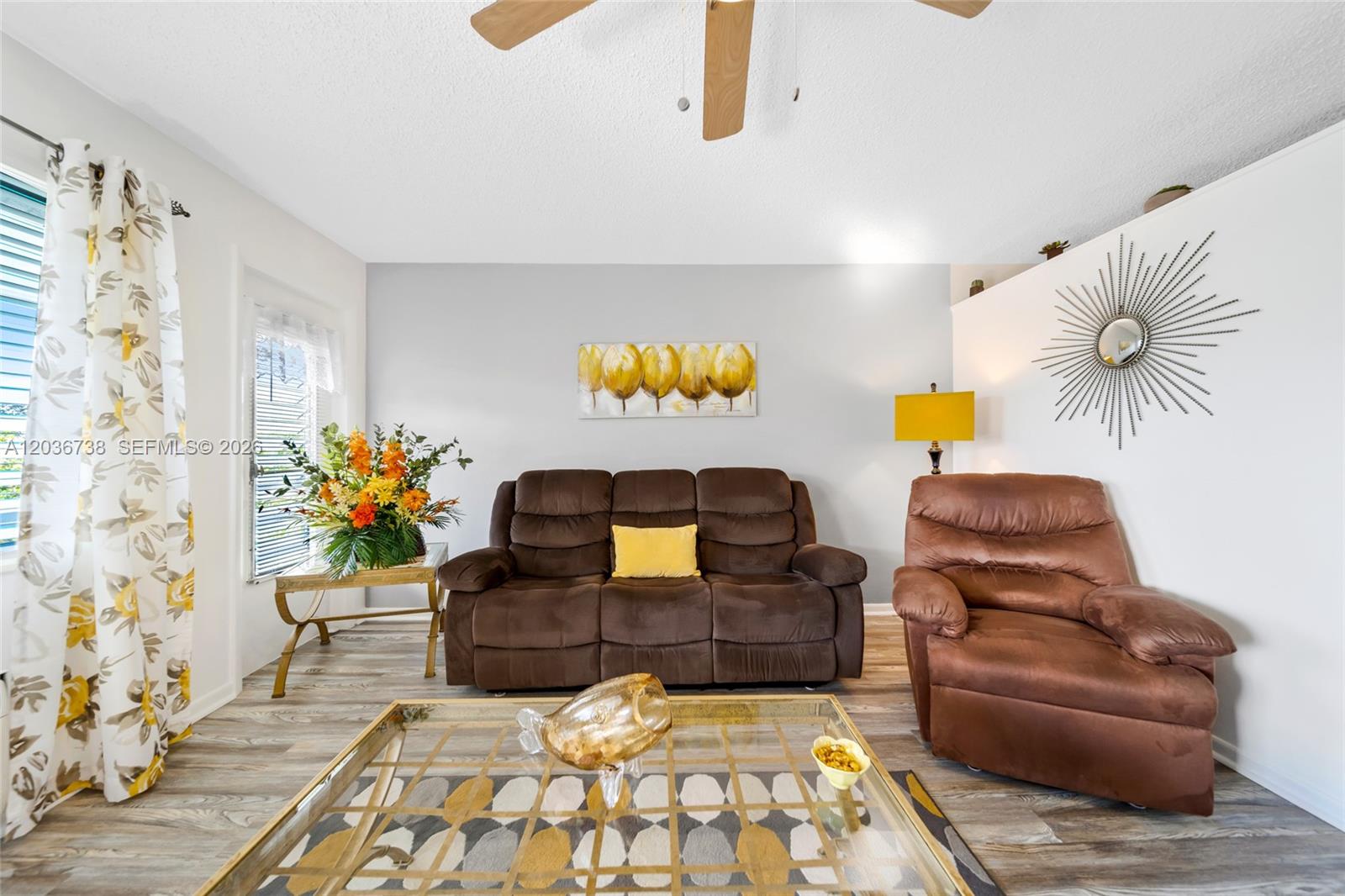 A living room features a brown sofa, a recliner, and a glass-topped coffee table — 15610 NE 6th Ave # 34C, Miami FL 33162, MIAMI, FL