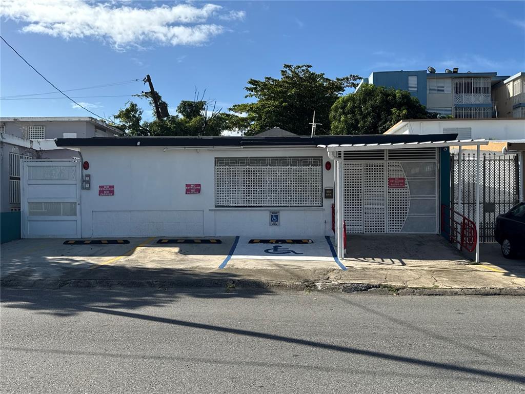 A single-story white building features a designated handicap parking space and two additional parking spots — N618 CALLE JULIO ANDINO, SAN JUAN, PR