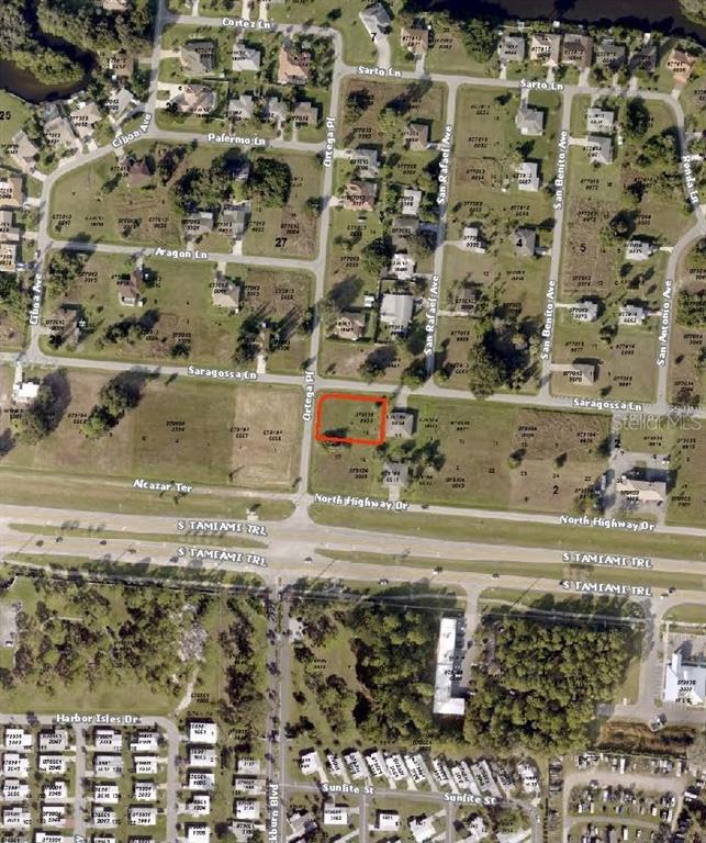 This is an aerial map showing a vacant lot outlined in red near a highway — 12000 TAMIAMI LOTS 15 & 16 TRAIL S, NORTH PORT, FL