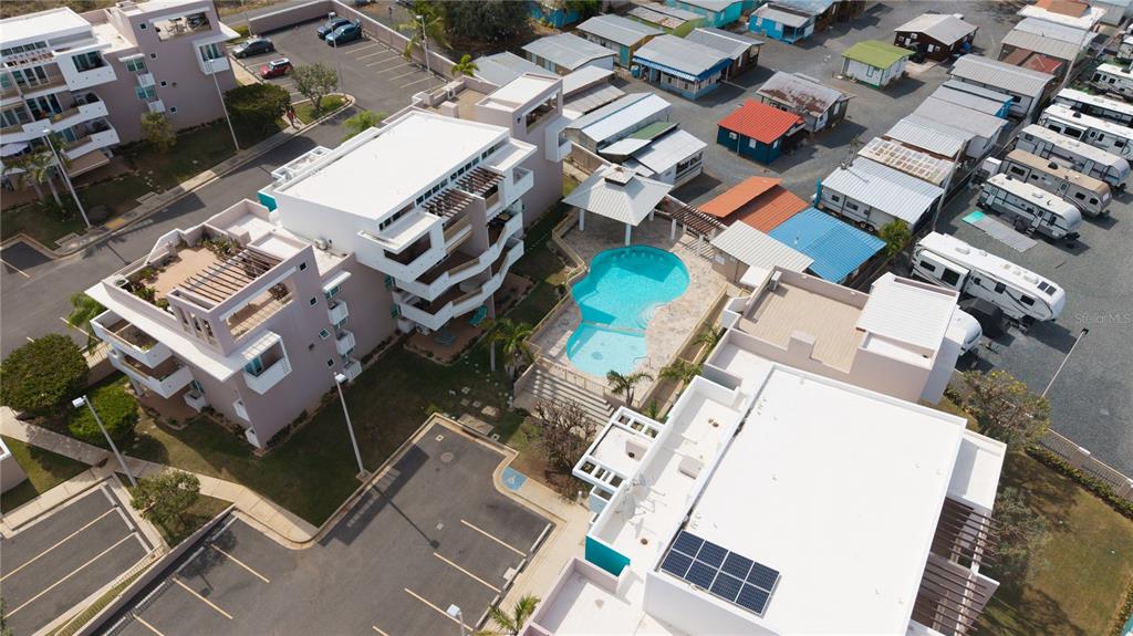An aerial view shows a multi-story apartment complex with a swimming pool and parking area — Carretera 301 MANUEL PAGAN FERNANDEZ Apt 324, BOQUERON, PR