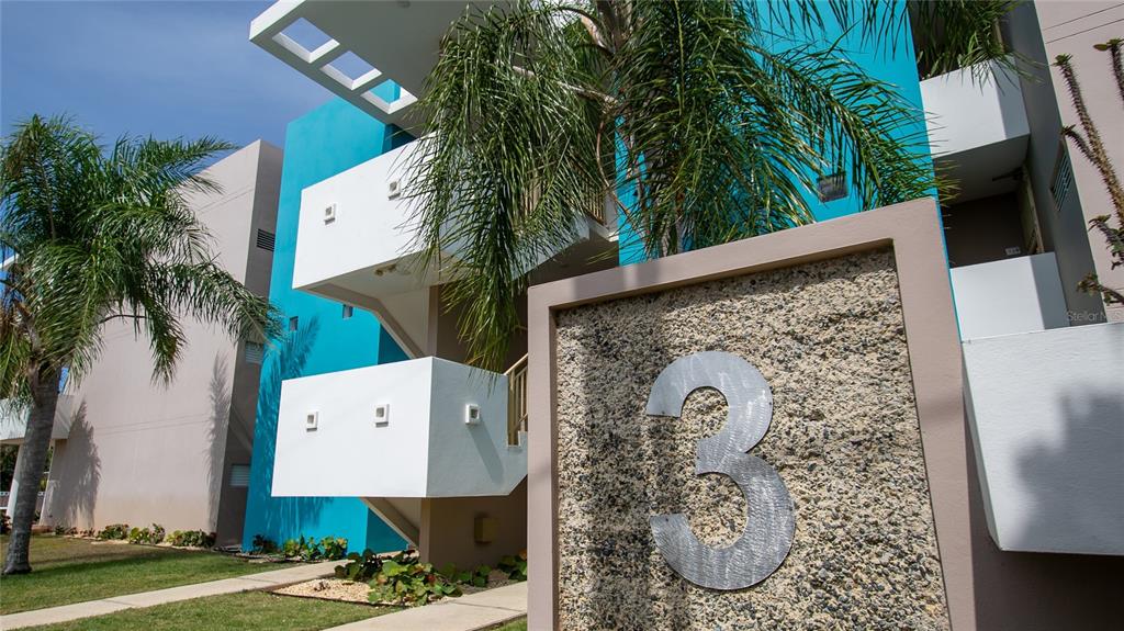 A low-angle view of a multi-story apartment building exterior with a large number three sign — Carretera 301 MANUEL PAGAN FERNANDEZ Apt 324, BOQUERON, PR