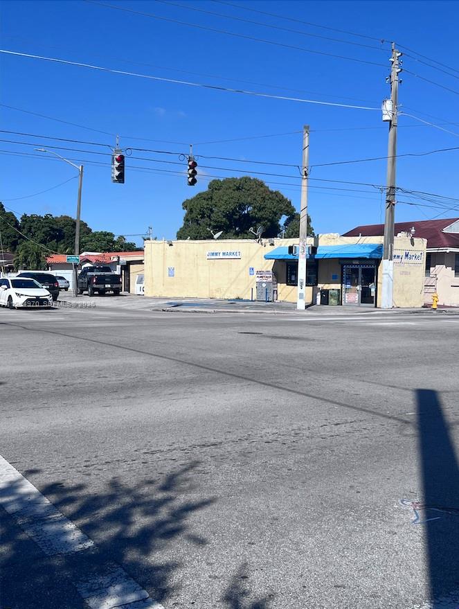 A yellow commercial building with a blue awning stands at a street intersection — 1540 SW 22nd Ave, Miami FL 33145, MIAMI, FL