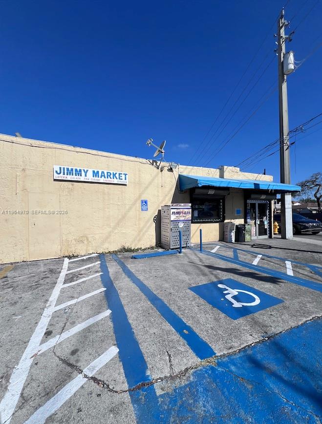 An exterior view of Jimmy Market with a blue-painted handicap parking space in front — 1540 SW 22nd Ave, Miami FL 33145, MIAMI, FL