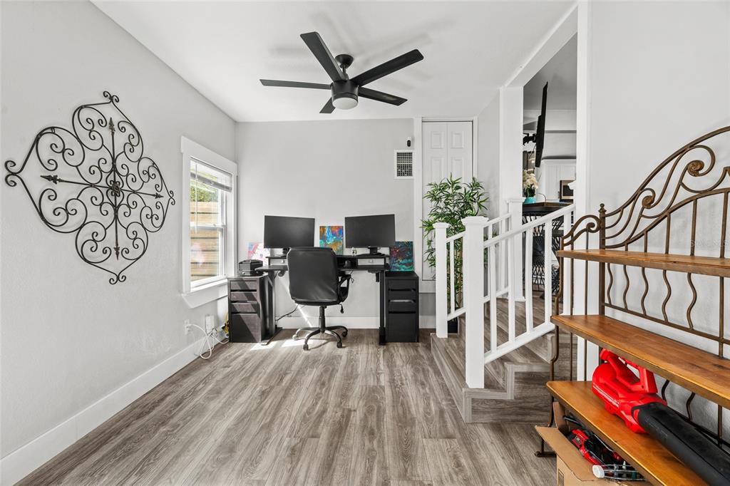A home office features a desk with two monitors, wood-look flooring, and a ceiling fan — 5135 OLD BRADENTON ROAD, SARASOTA, FL