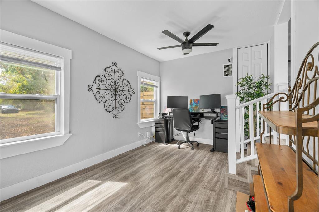 A home office with wood-look flooring, a ceiling fan, and a desk with two monitors — 5135 OLD BRADENTON ROAD, SARASOTA, FL