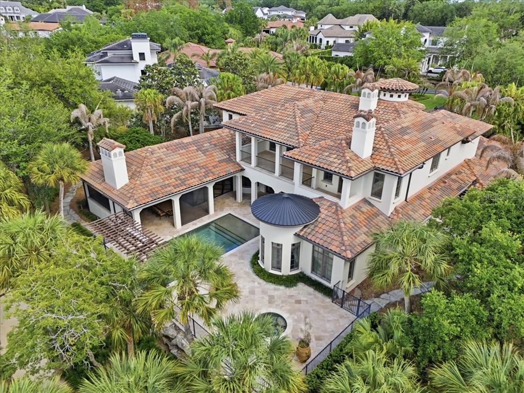 An aerial view of a two-story house with a tile roof, pool, and patio — 4906 AVIVA GARDEN COURT, WINDERMERE, FL