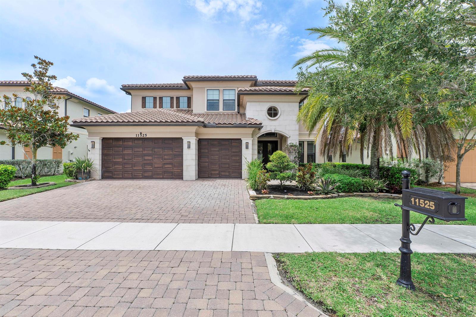 A two-story house with a paved driveway, a three-car garage, and a palm tree — 11525 NW 81st Place, Parkland FL 33076, PARKLAND, FL
