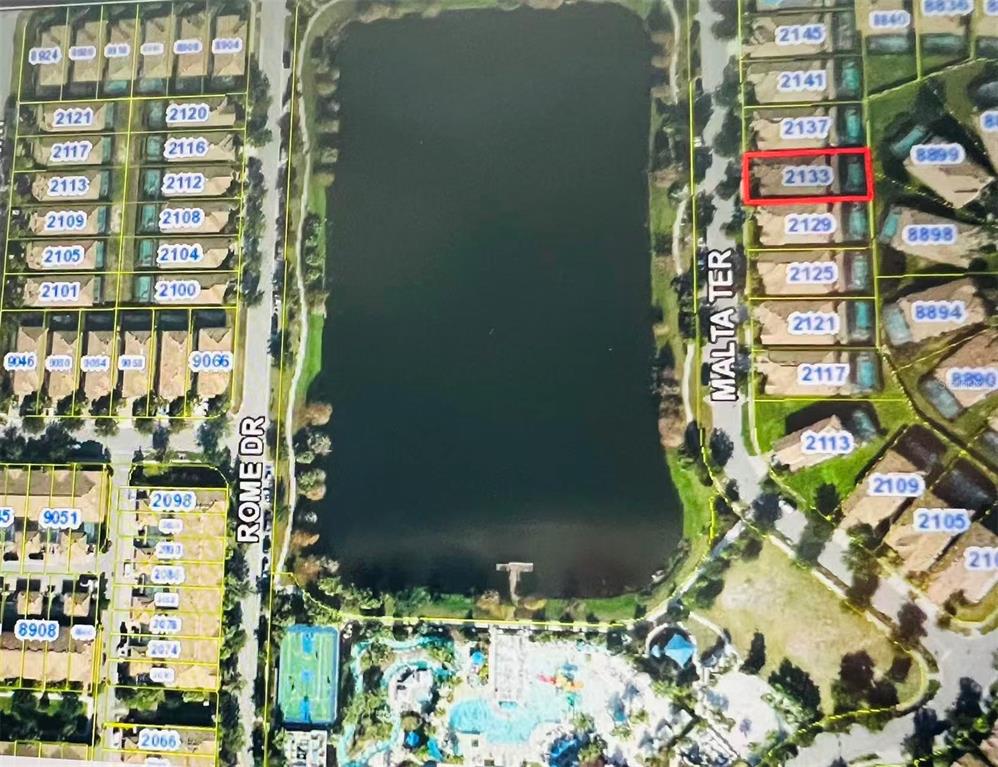 This is an aerial map showing residential properties surrounding a lake and community amenities — 2137 MALTA TERRACE, KISSIMMEE, FL