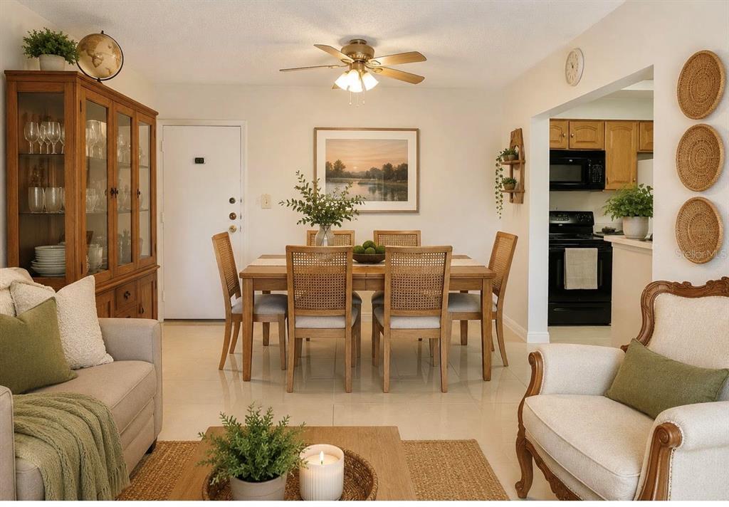 A dining area with a wooden table and chairs sits between a living room and kitchen — 6831 W 14 COURT UNIT 306, HIALEAH, FL