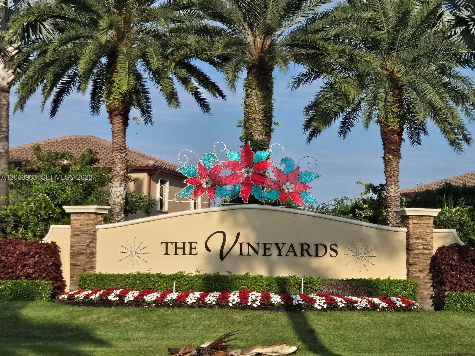 The entrance sign for The Vineyards features decorative floral lighting and palm trees — 634 SE 37 Ave, Homestead FL 33033, HOMESTEAD, FL