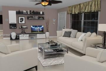 This is a digital rendering of a modern living room with neutral furniture and shelving — 165 SE 4 AVENUE # 165, Deerfield Beach FL 33441, DEERFIELD BEACH, FL