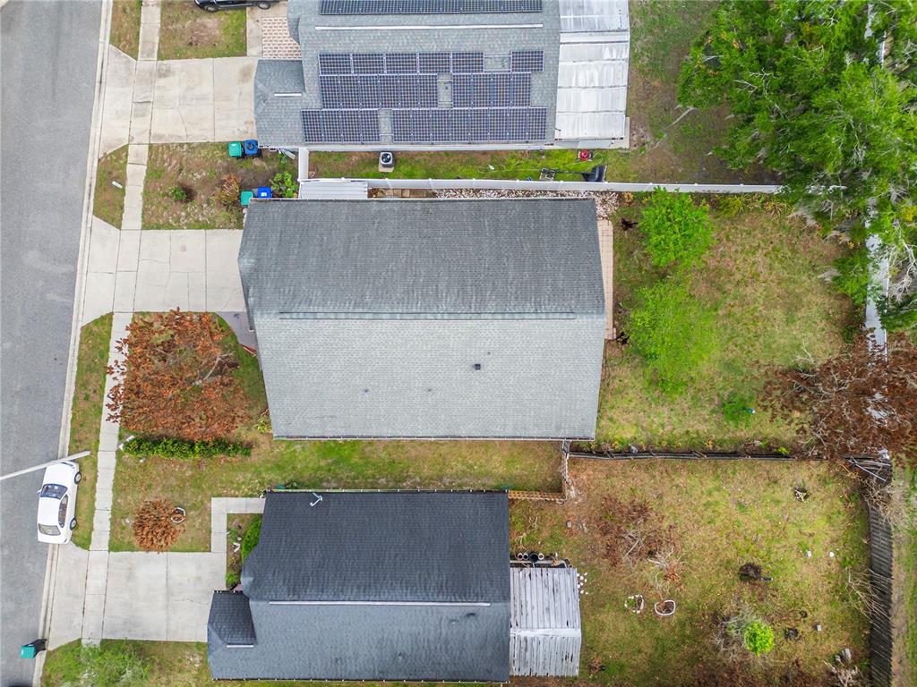 An aerial view shows three residential houses with yards and driveways along a street — 3013 CATHERINE WHEEL COURT, ORLANDO, FL