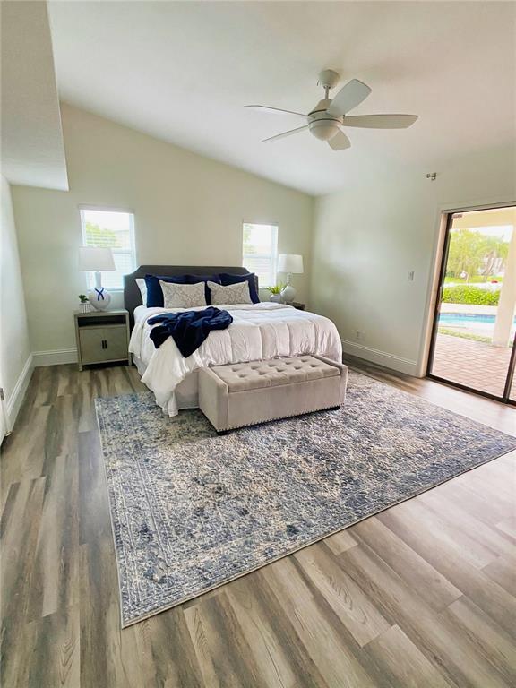 A living room with a large sectional sofa, patterned area rug, and open kitchen — 2400 LAUDERDALE COURT, ORLANDO, FL