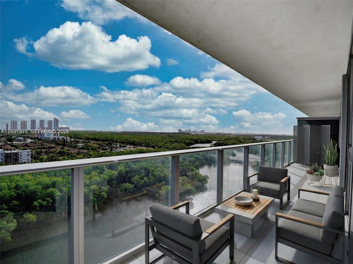 An empty living area with light tile flooring, white walls, and floor-to-ceiling windows overlooking water — 16385 Biscayne Blvd # 1615, North Miami Beach FL 33160, NORTH MIAMI BEACH, FL