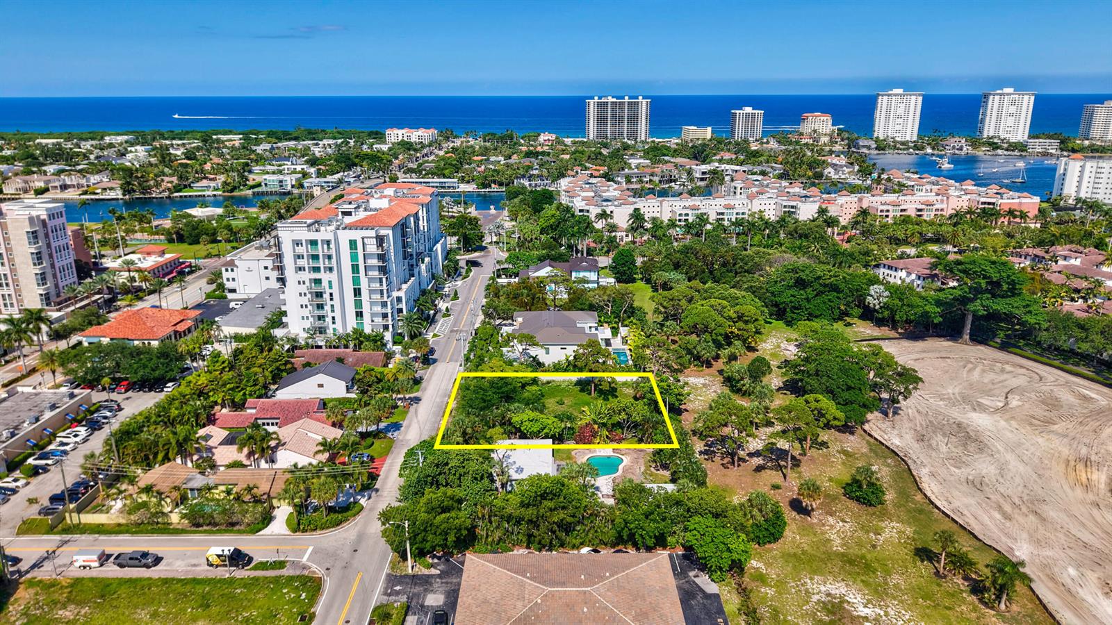 An aerial view shows a vacant, rectangular lot surrounded by trees and residential buildings — 442 E Royal Palm Road, Boca Raton FL 33432, BOCA RATON, FL