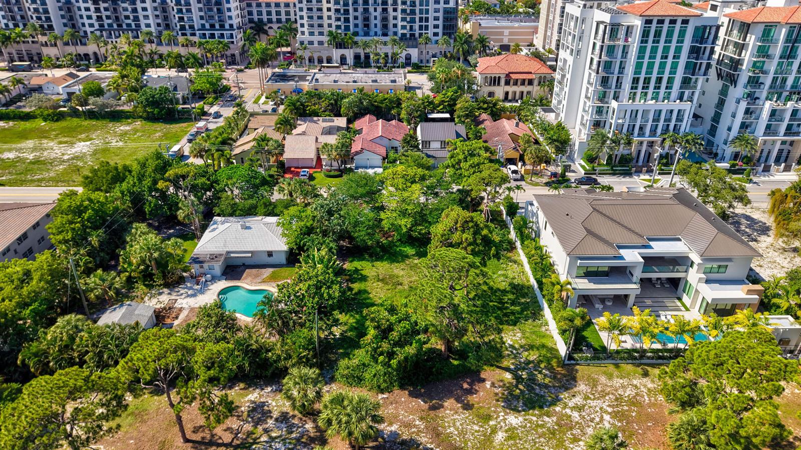 An aerial view shows a residential neighborhood with houses, swimming pools, and large apartment buildings — 442 E Royal Palm Road, Boca Raton FL 33432, BOCA RATON, FL