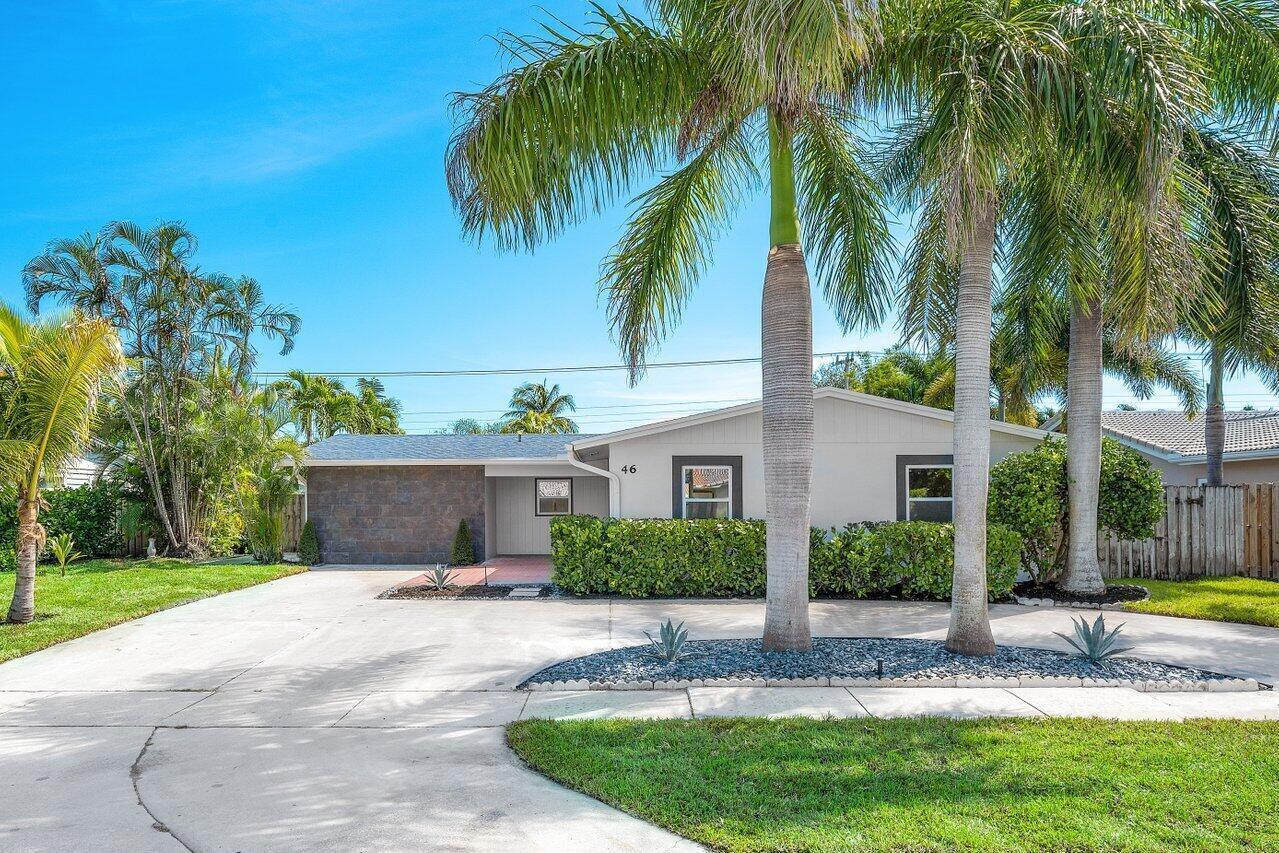 A single-story house with a stone facade, palm trees, and a concrete driveway — 46 SW 9th Avenue, Boca Raton FL 33486, BOCA RATON, FL