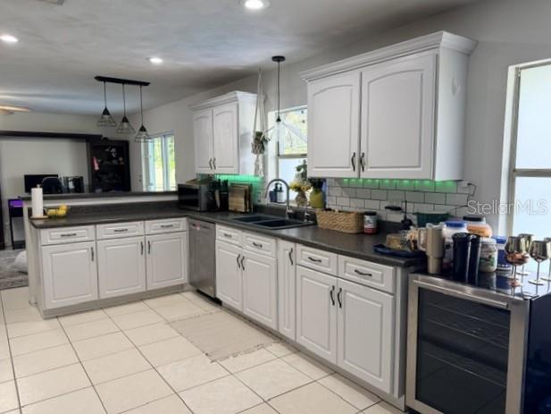 A kitchen with white cabinets, dark countertops, a subway tile backsplash, and tile flooring — 706 VENTERS STREET, PORT ORANGE, FL
