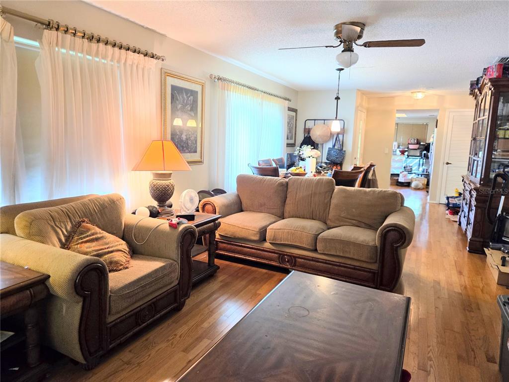 A kitchen with white cabinets, granite countertops, stainless steel appliances, and hardwood flooring — 2367 FLANDERS WAY UNIT D, SAFETY HARBOR, FL