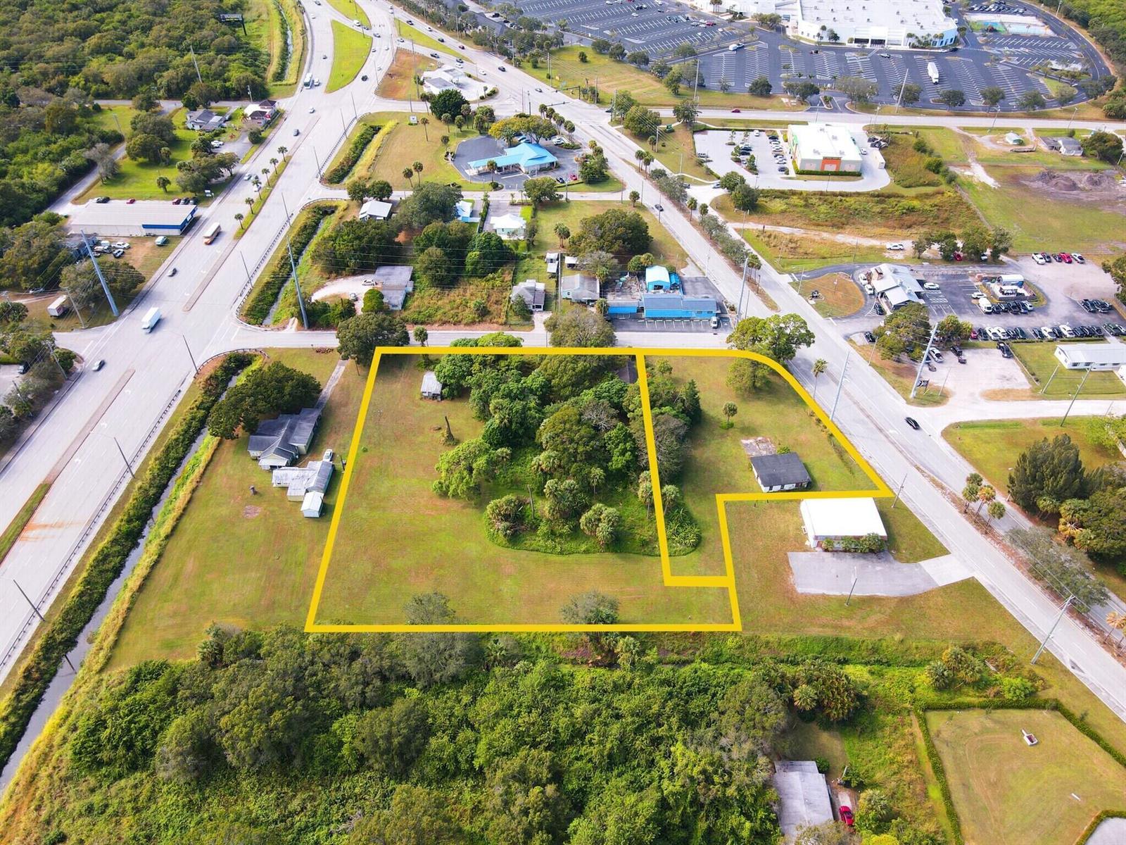 An aerial view shows a large, irregularly shaped plot of land outlined in yellow — 3805 Okeechobee Road, Fort Pierce FL 34947, FORT PIERCE, FL