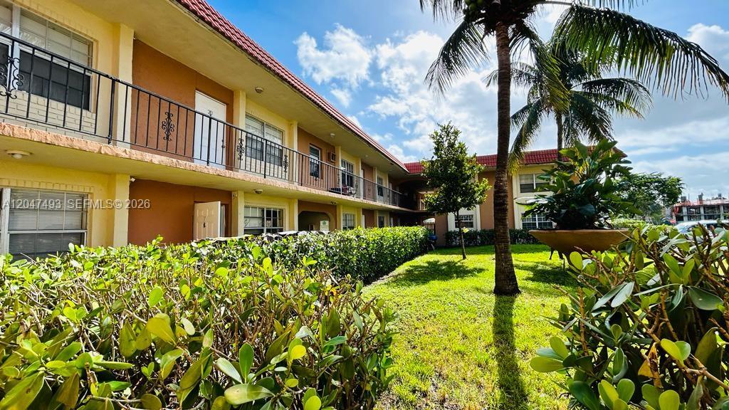 A two-story apartment building with a balcony, palm trees, and a landscaped lawn — 978 SW 10th Dr # 21, Pompano Beach FL 33060, POMPANO BEACH, FL