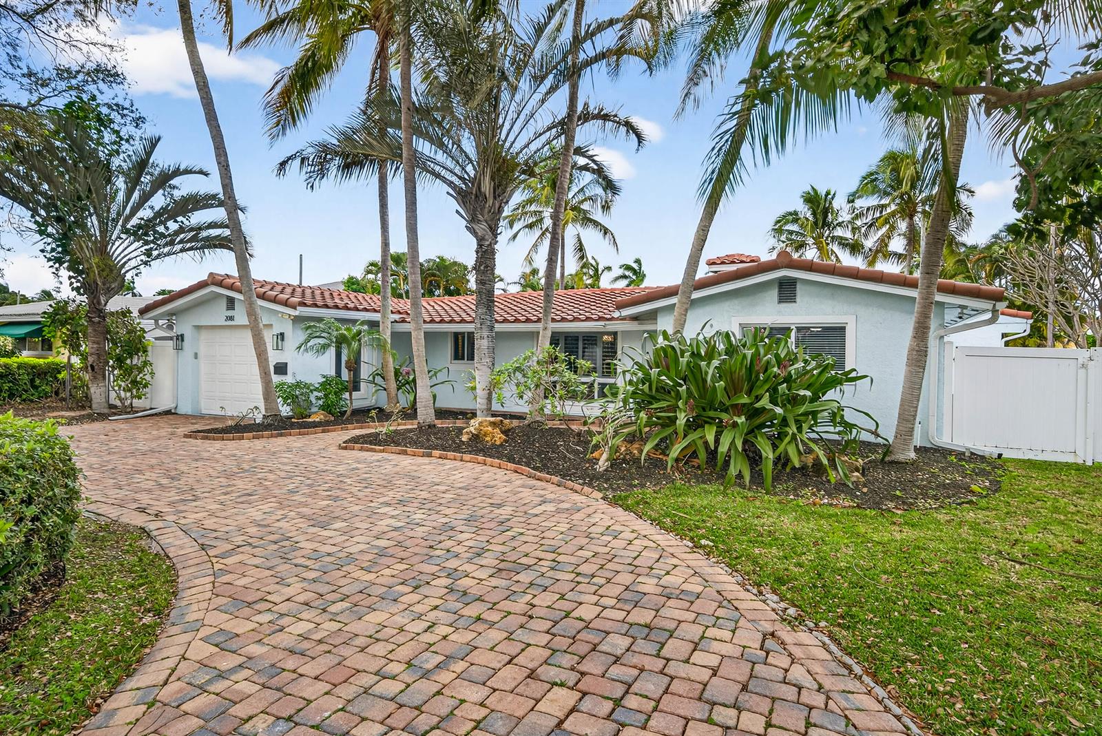 A light blue single-story house with a tiled roof and a brick paver driveway — 2081 NE 25th Street, Lighthouse Point FL 33064, LIGHTHOUSE POINT, FL
