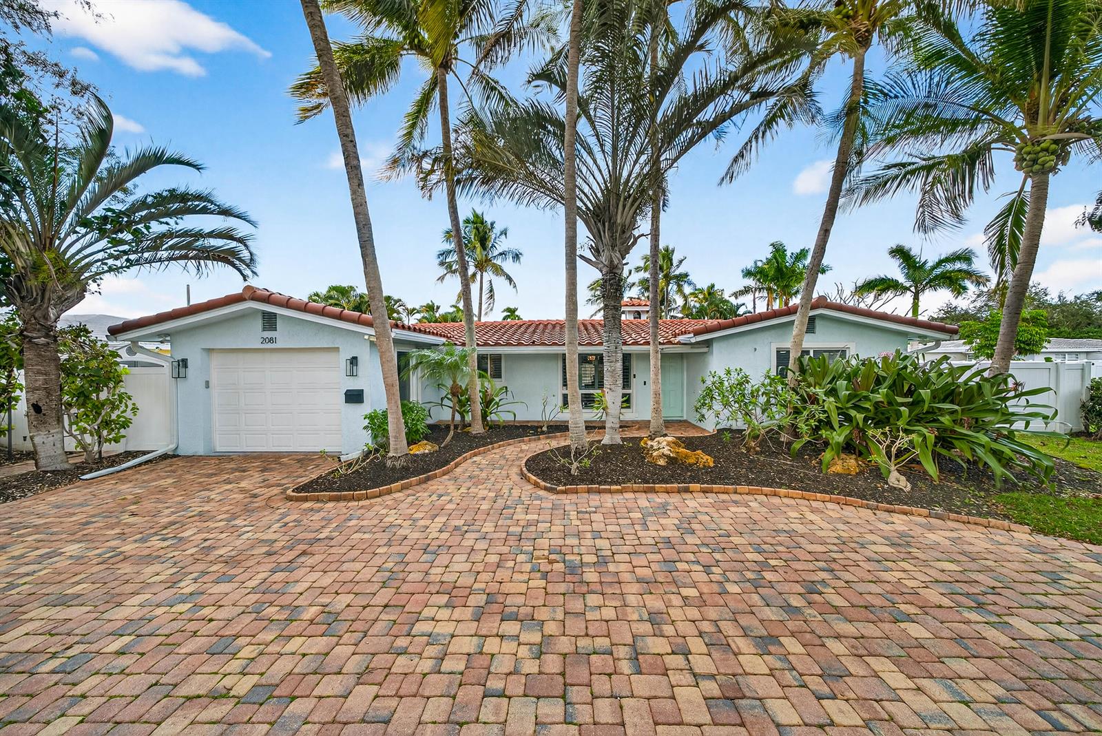 A single-story house with a paved driveway, palm trees, and a red tile roof — 2081 NE 25th Street, Lighthouse Point FL 33064, LIGHTHOUSE POINT, FL