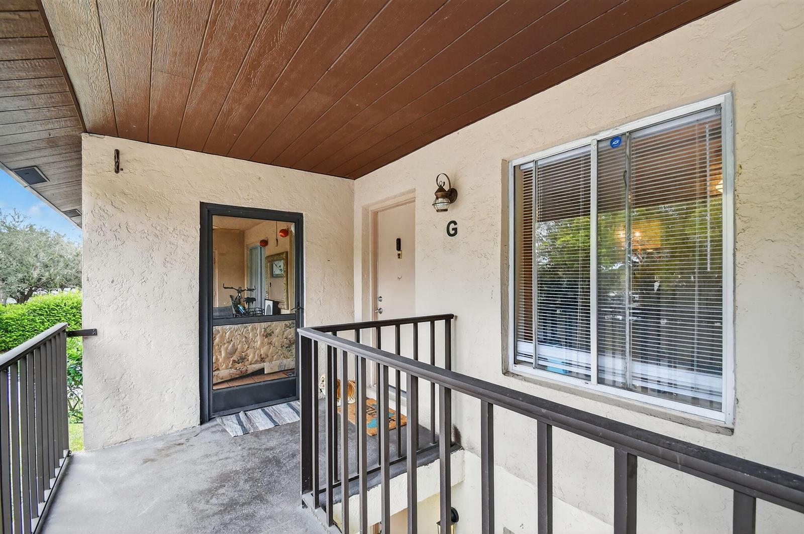 An exterior view of a building entrance with a door labeled G and a window — 4191 S 57th Avenue G Avenue, FL 33463, FL