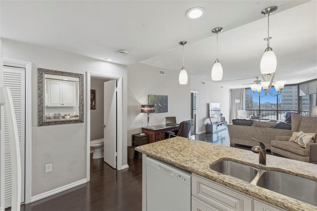 A kitchen island with granite countertops overlooks a living area and a home office space — 1 BEACH DRIVE SE UNIT 1109, ST PETERSBURG, FL