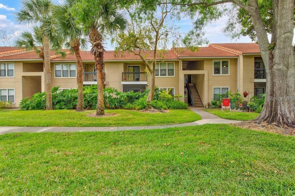 A two-story apartment building with a tan stucco exterior and a red tile roof — 4049 CROCKERS LAKE BOULEVARD UNIT 25, SARASOTA, FL