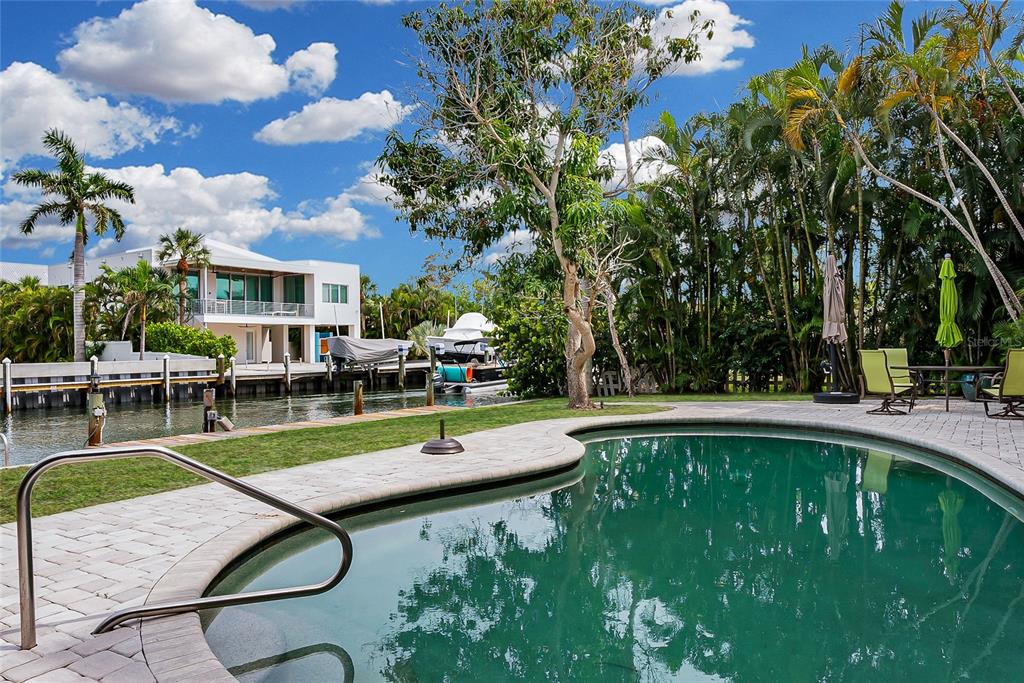 A three-story yellow house features a swimming pool, a spiral staircase, and multiple balconies — 614 NORTON STREET, LONGBOAT KEY, FL