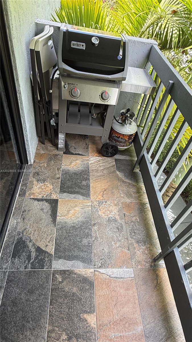A balcony features slate-look tile flooring, a Weber gas grill, and a propane tank — 13675 SW 62nd St # 3, Miami FL 33183, MIAMI, FL