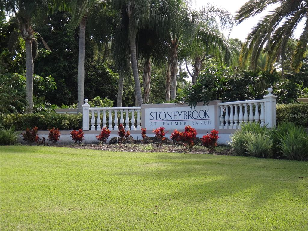 A stone monument sign for Stoneybrook at Palmer Ranch sits in a landscaped front yard — 4122 WESTBOURNE CIRCLE, SARASOTA, FL