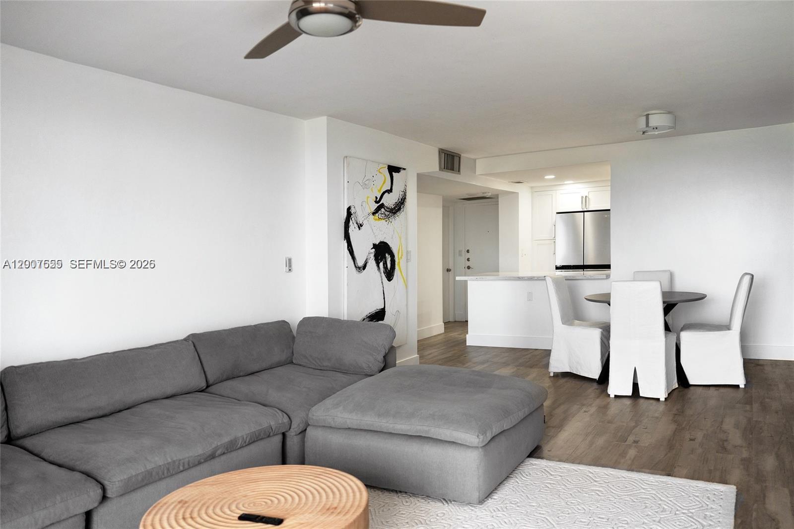 A living room features a gray sectional sofa, a round wooden table, and dining chairs — 1600 S Ocean Dr # 17D, Hollywood FL 33019, HOLLYWOOD, FL