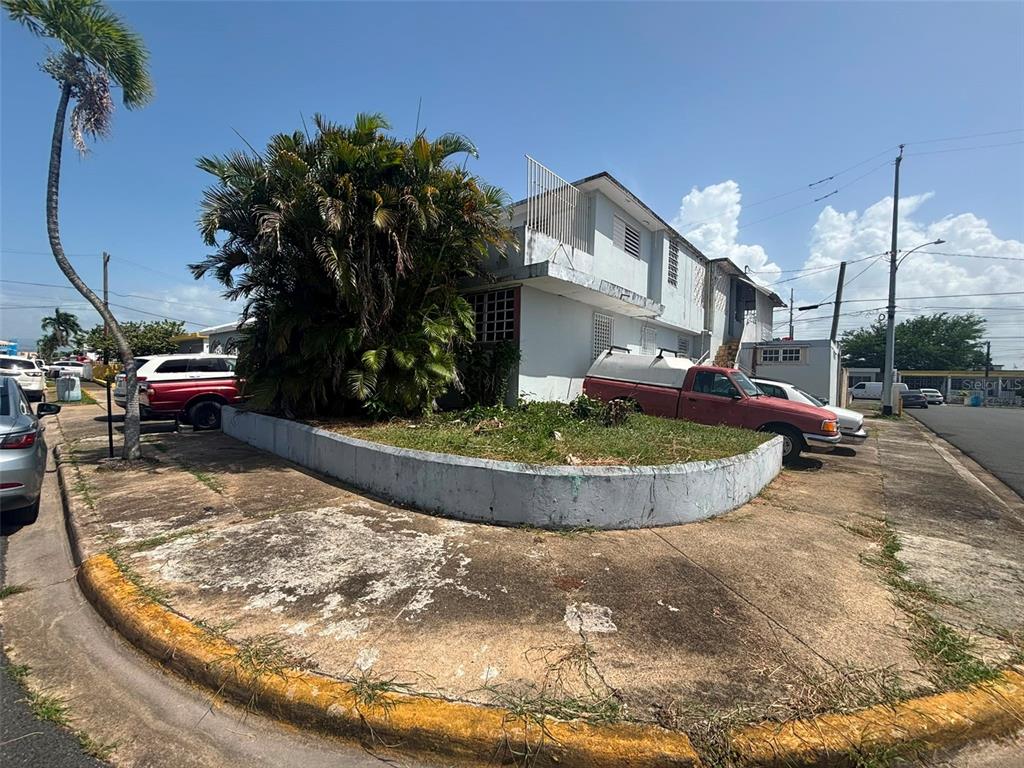 A two-story white building with a corner planter and parked vehicles on a street — 950(19AK) LINANCERO ST EXT COUNTRY CLUB DEVELOPMENT, SAN JUAN, PR