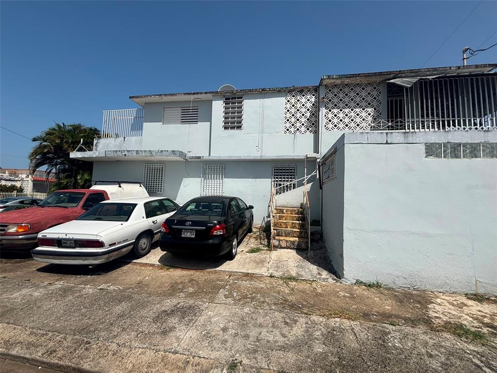 A two-story concrete house with a flat roof, exterior stairs, and three parked cars — 950(19AK) LINANCERO ST EXT COUNTRY CLUB DEVELOPMENT, SAN JUAN, PR