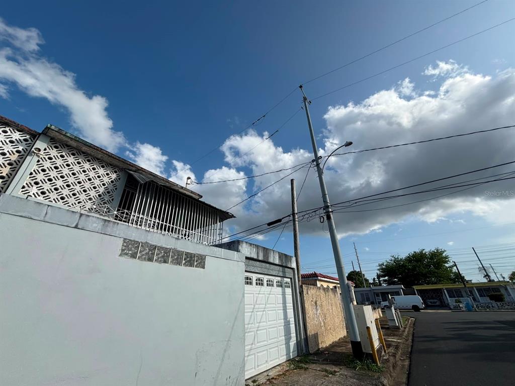 A view of a concrete wall, a garage door, and a utility pole under a sky — 950(19AK) LINANCERO ST EXT COUNTRY CLUB DEVELOPMENT, SAN JUAN, PR